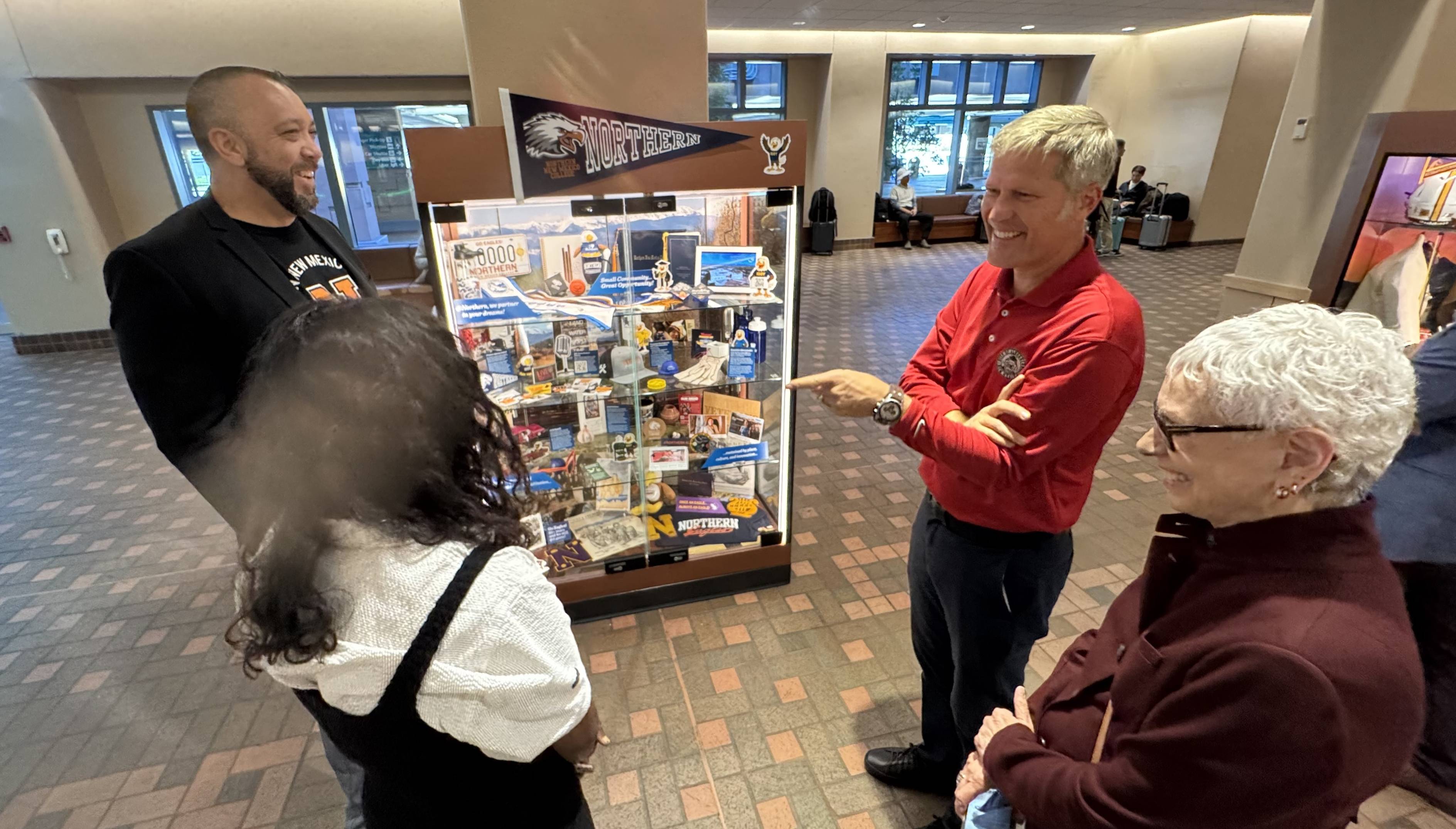 Scott Stokes, Sandy Krolick and Milam Shah having a conversation with Mayor Tim Keller at the Sunport